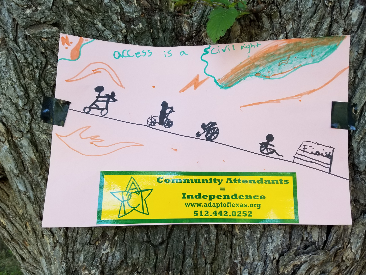 Kid’s drawing of a line of people in various kinds of wheelchairs and scooters. Above the slogan Access is a Civil Right. Below a Community Attendants bumper sticker.